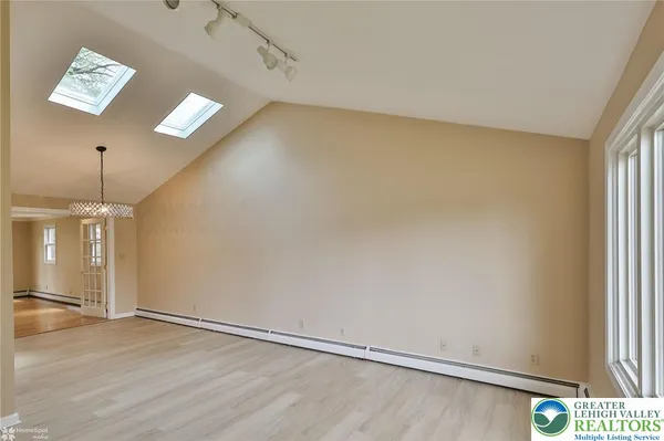 wooden floor in an empty room with a fireplace