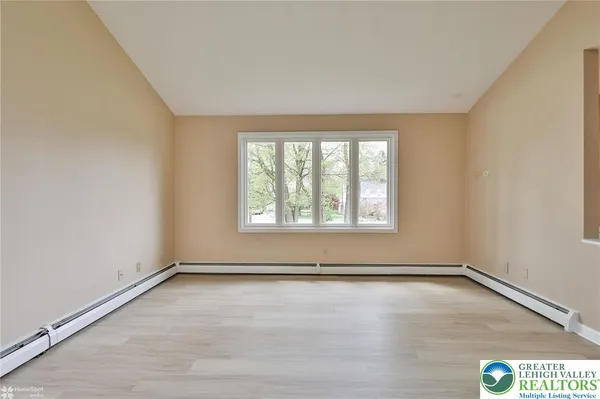 a view of an empty room with a window