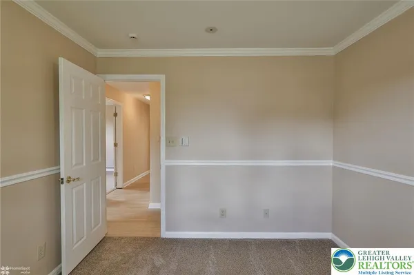 a living room with a couch and large window with wooden floor