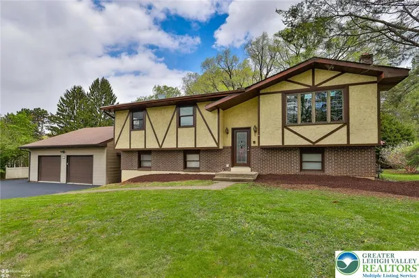 a kitchen with stainless steel appliances granite countertop a refrigerator a stove a sink and a microwave