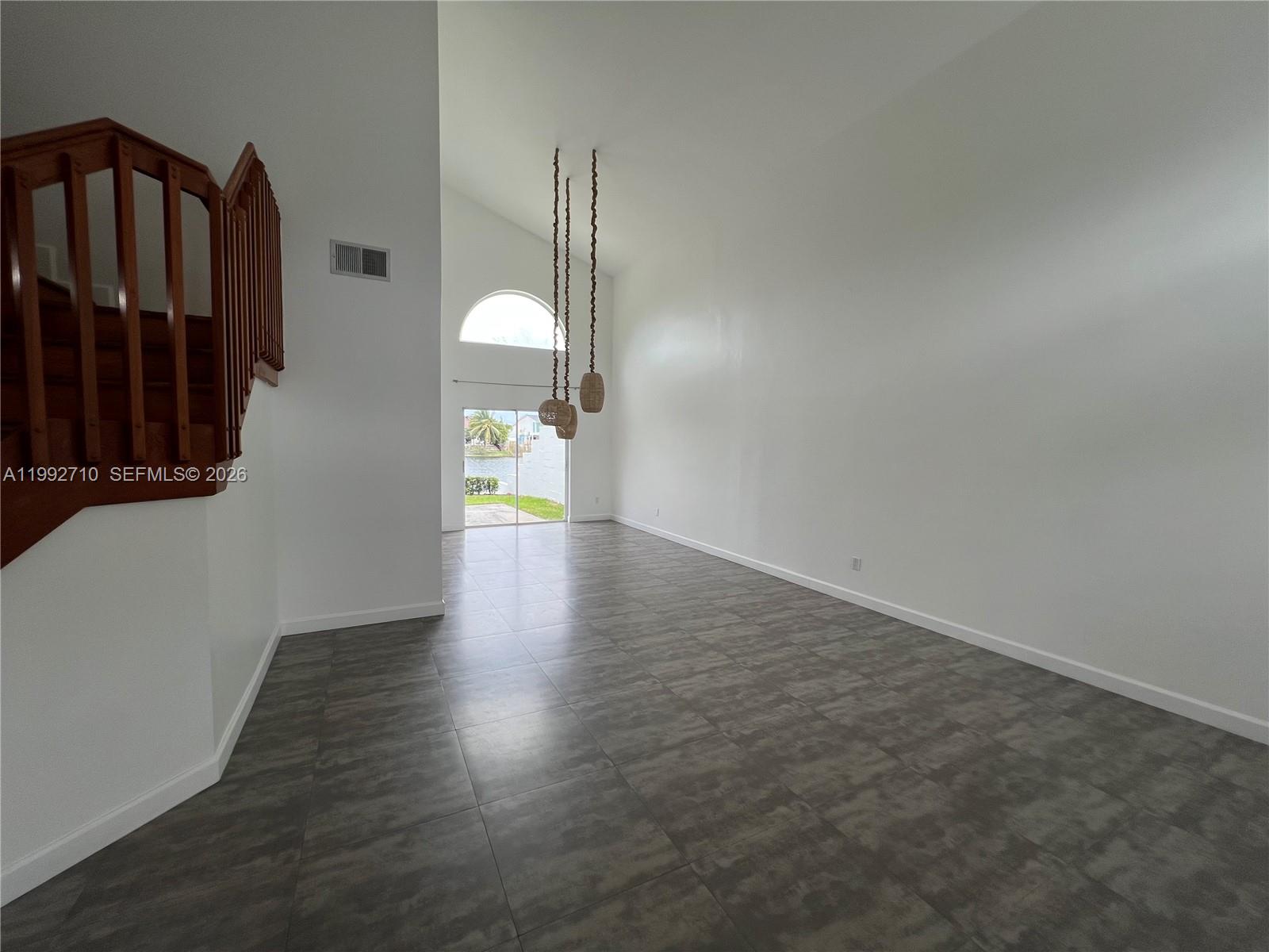 15511 Southwest 59th Street Miami, FL 33193 - Photo 11 of 34 a view of an empty room with wooden floor