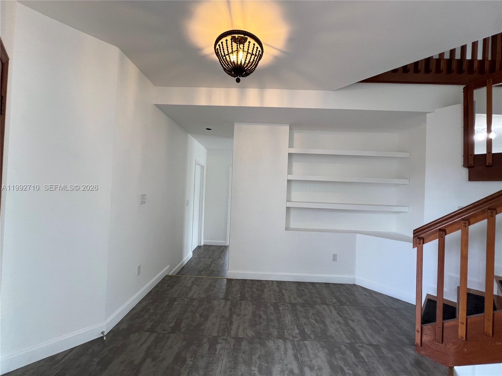 15511 Southwest 59th Street Miami, FL 33193 - Photo 17 of 34 a view of an empty room with wooden floor