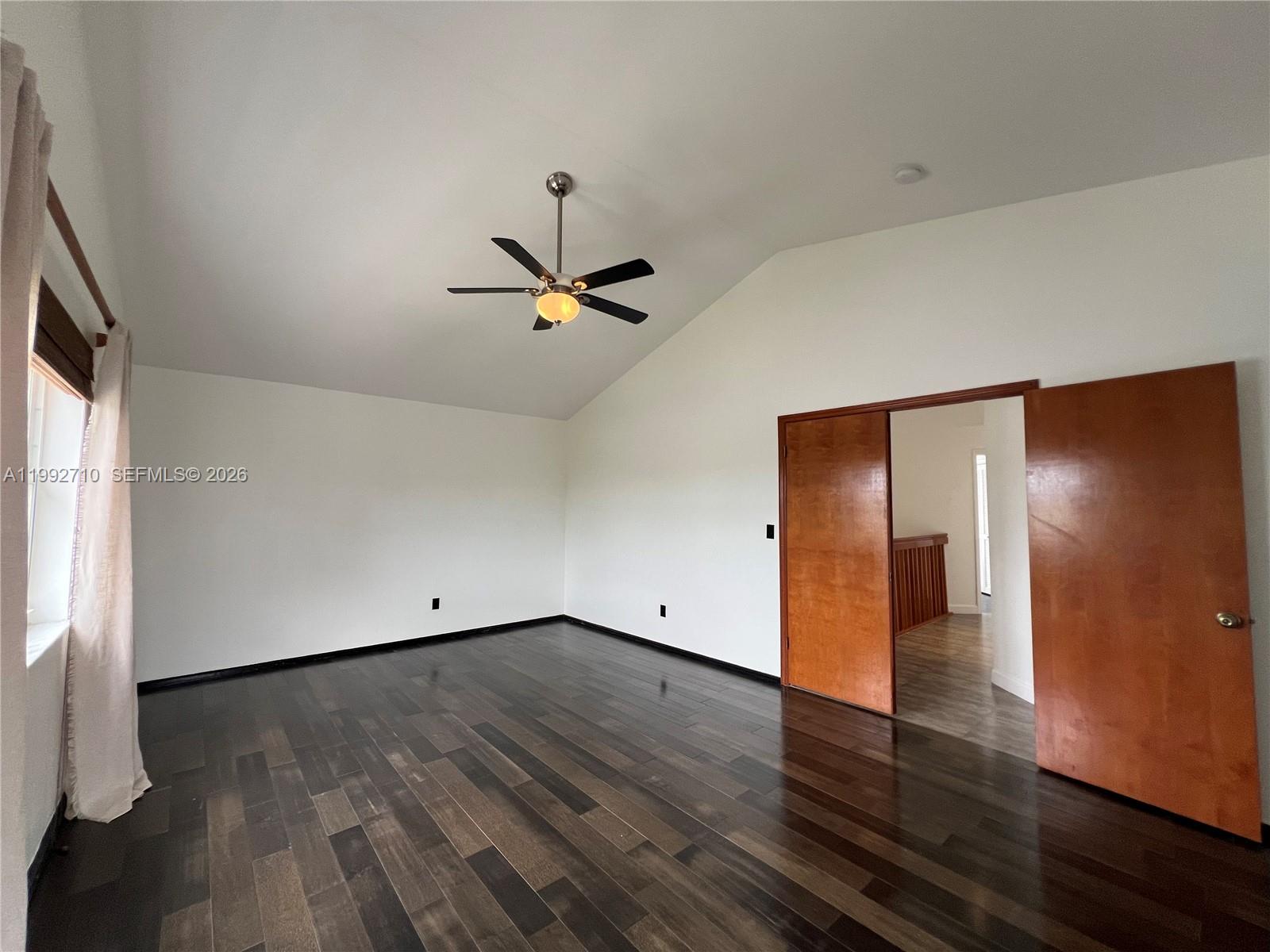 15511 Southwest 59th Street Miami, FL 33193 - Photo 18 of 34 an empty room with wooden floor and windows