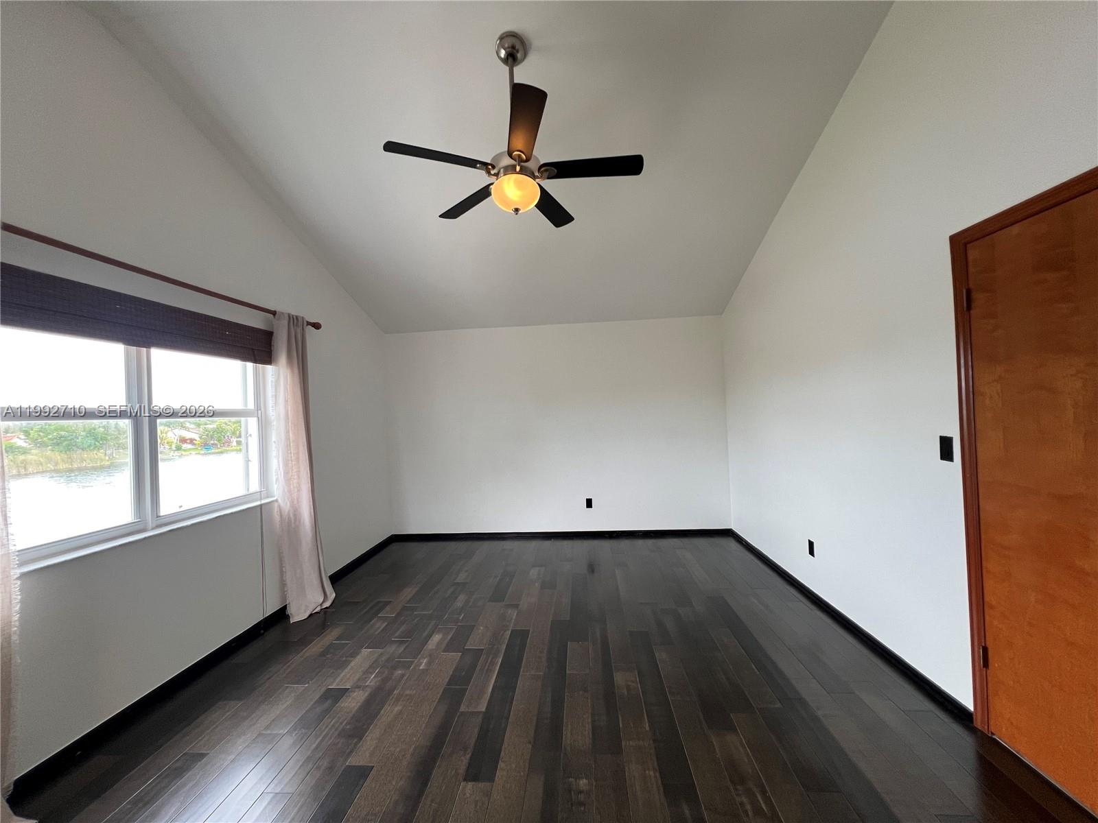 15511 Southwest 59th Street Miami, FL 33193 - Photo 19 of 34 wooden floor in an empty room with a window