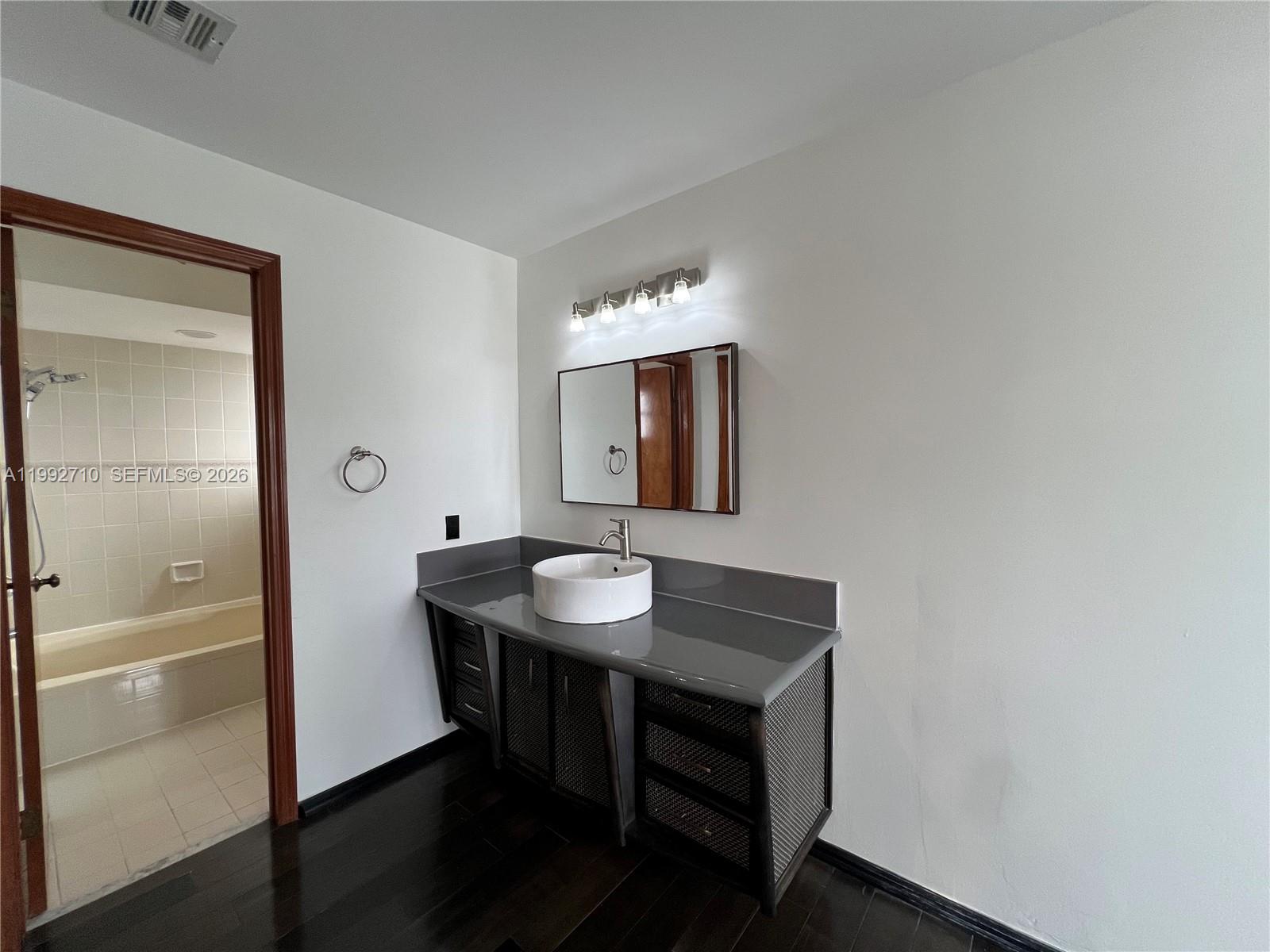 15511 Southwest 59th Street Miami, FL 33193 - Photo 20 of 34 a bathroom with a sink and a mirror