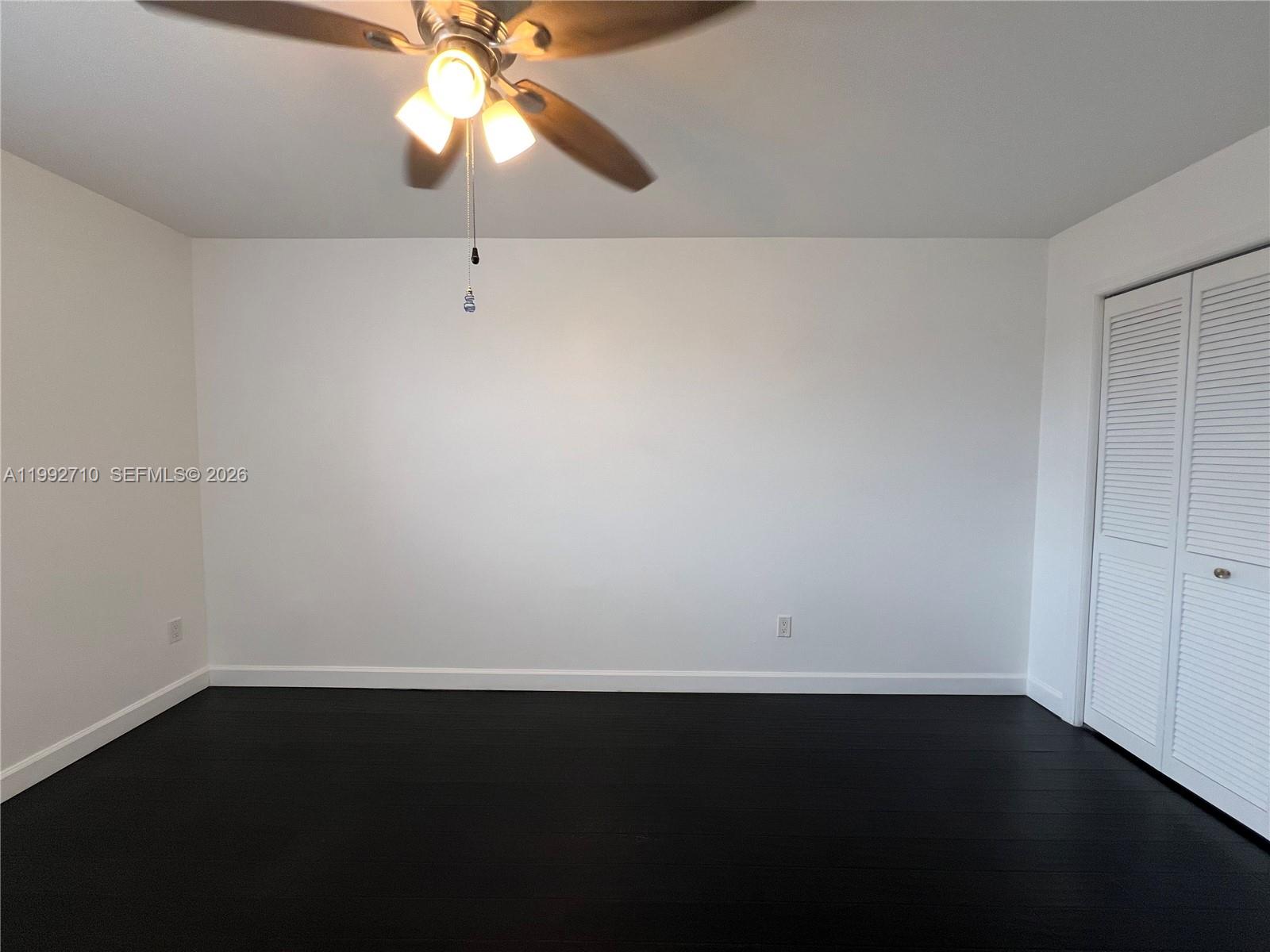 15511 Southwest 59th Street Miami, FL 33193 - Photo 22 of 34 a view of a room with wooden floor and fan