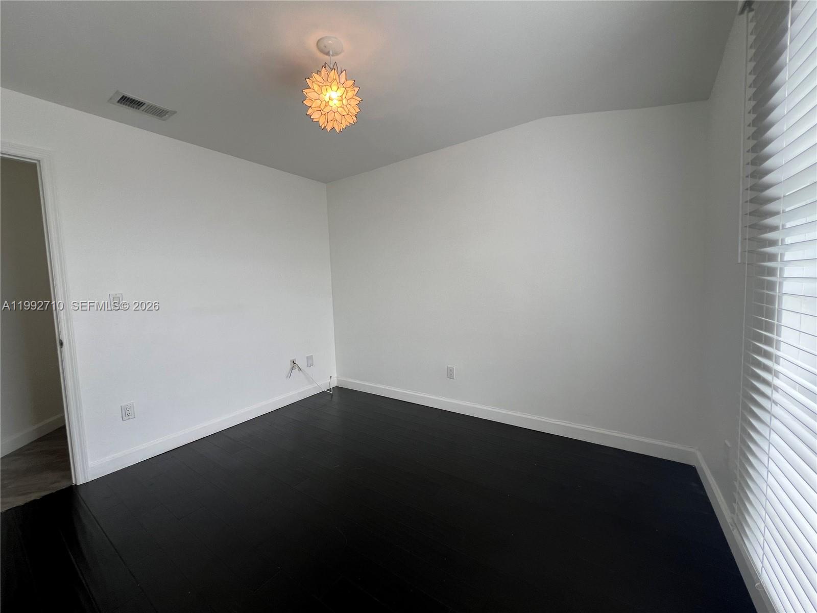 15511 Southwest 59th Street Miami, FL 33193 - Photo 25 of 34 an empty room with a window