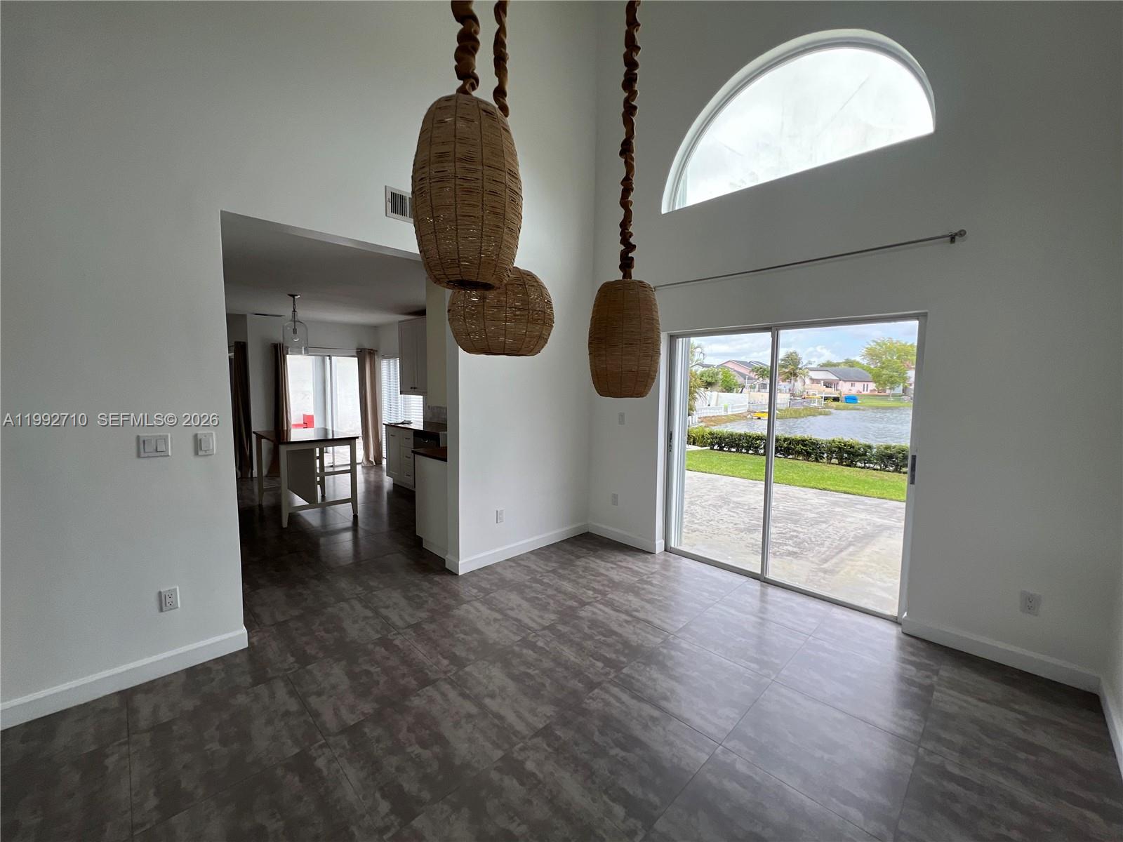 15511 Southwest 59th Street Miami, FL 33193 - Photo 5 of 34 a view of empty room with wooden floor and fan