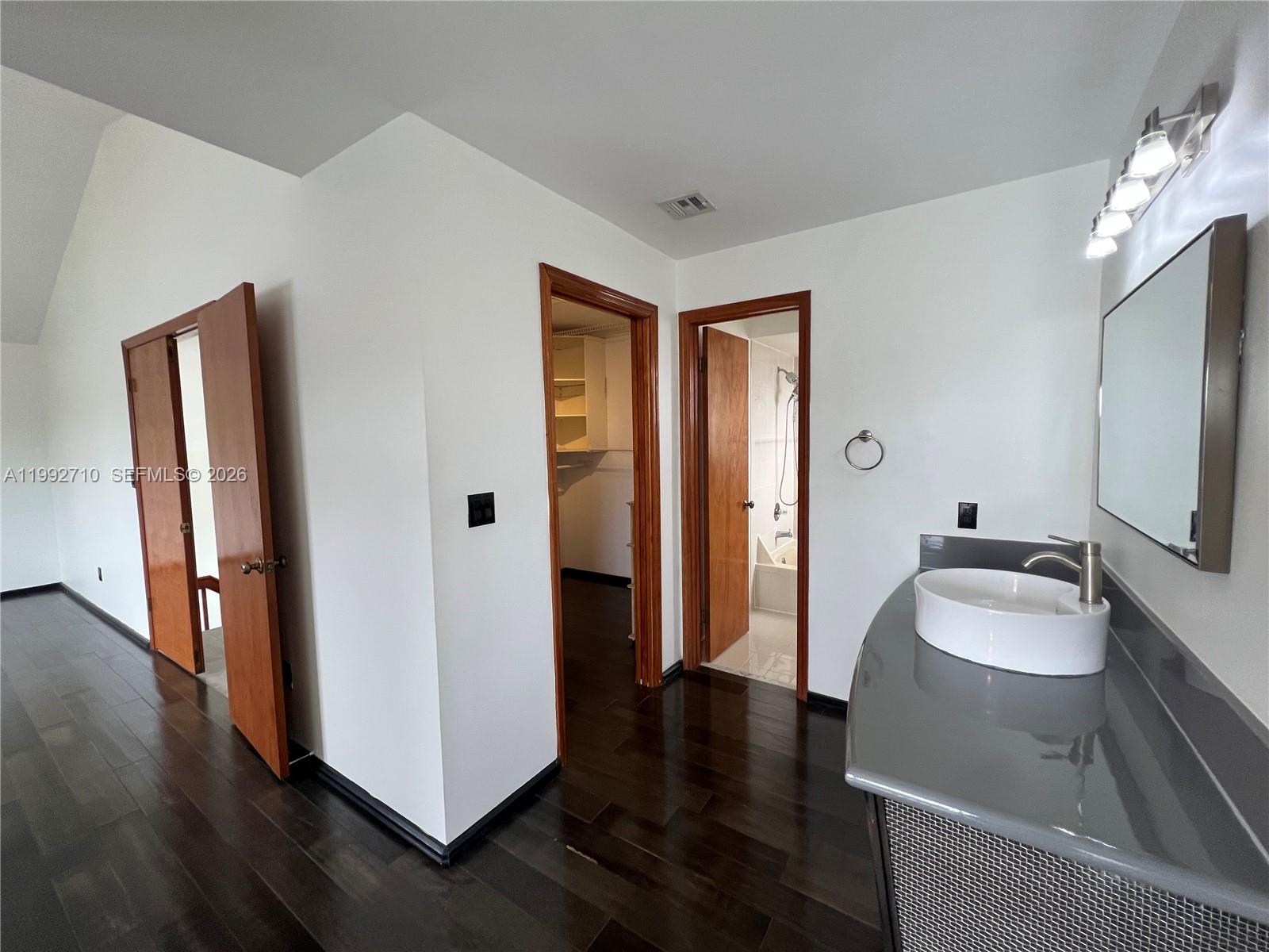 15511 Southwest 59th Street Miami, FL 33193 - Photo 7 of 34 a bathroom with a sink a toilet and a mirror