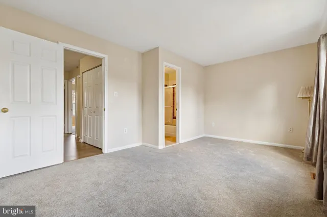 a view of an empty room and closet area
