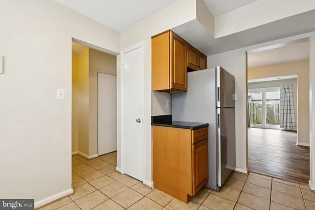 a utility room with windows and a refrigerator