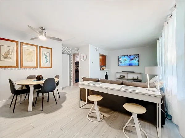 a view of a dining room with furniture and wooden floor