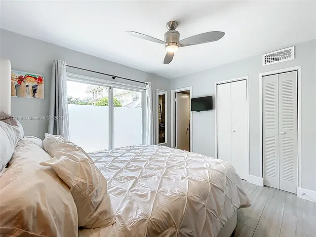 a bed sitting in a bedroom next to a window