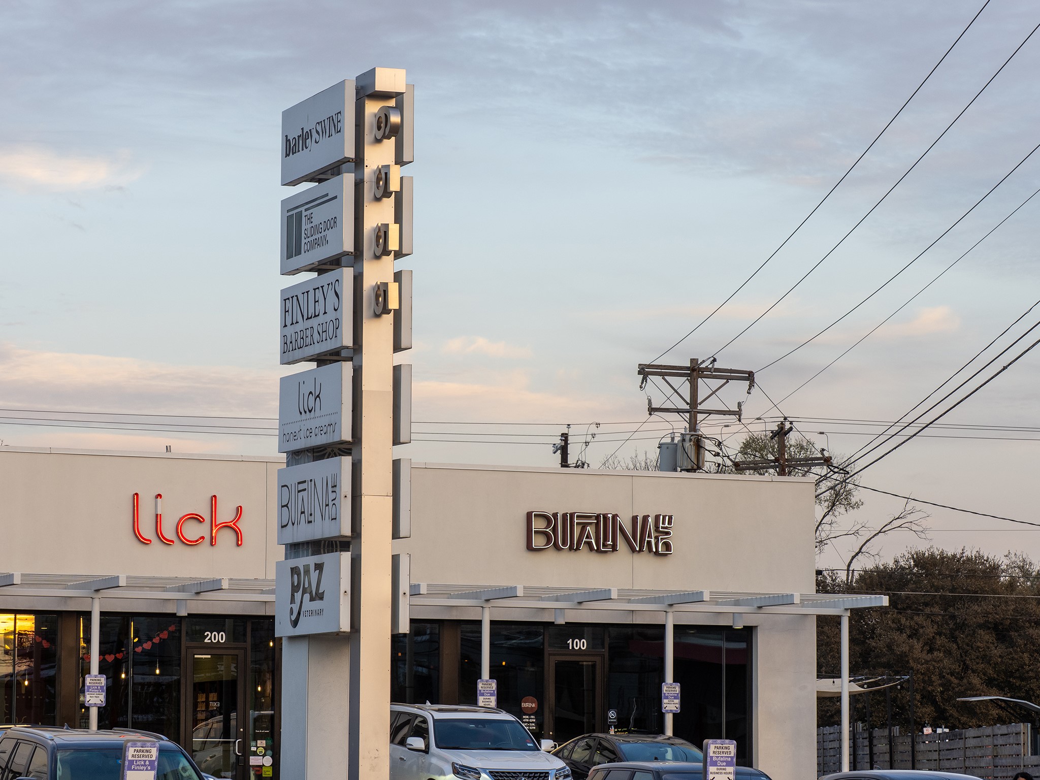 6444 Burnet Road, Unit 509 Austin, TX 78757 - Photo 25 of 32 A well-maintained commercial building with a modern facade and clear signage for multiple businesses.
