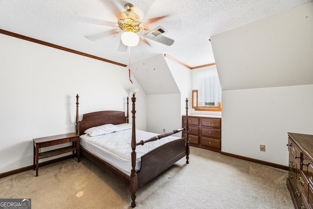 206 Ridge Circle Dublin, GA 31021 - Photo 16 of 23 a bed room with a bed and a chandelier