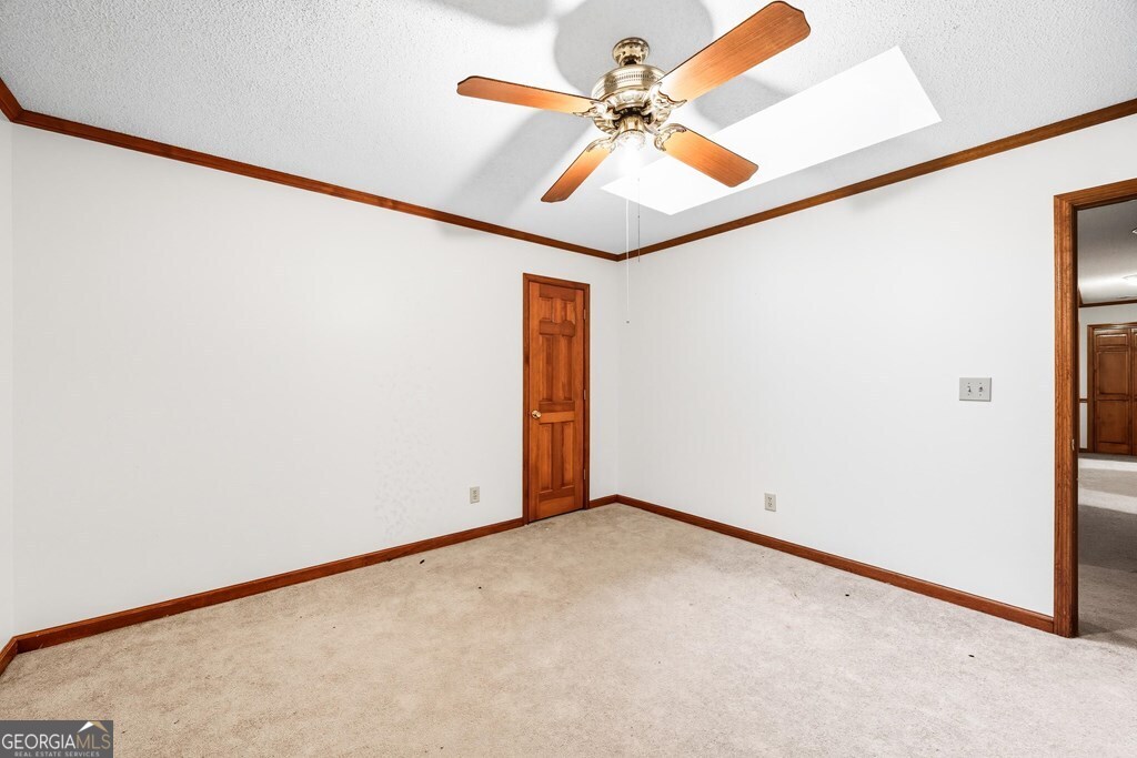 206 Ridge Circle Dublin, GA 31021 - Photo 17 of 23 an empty room with a window and a ceiling fan