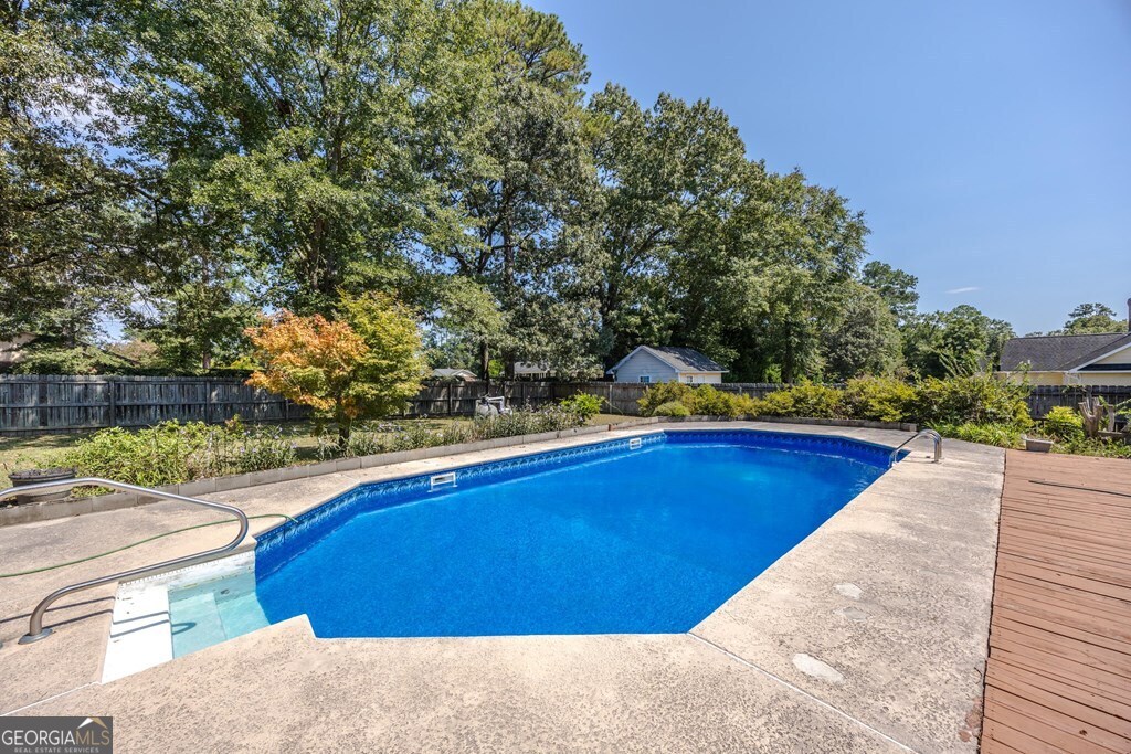 206 Ridge Circle Dublin, GA 31021 - Photo 19 of 23 a view of a swimming pool with a yard and plants