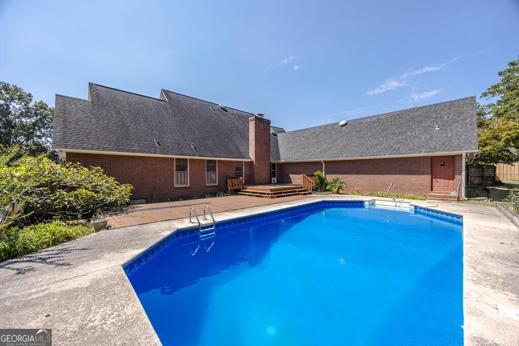 206 Ridge Circle Dublin, GA 31021 - Photo 20 of 23 a swimming pool with outdoor seating and yard