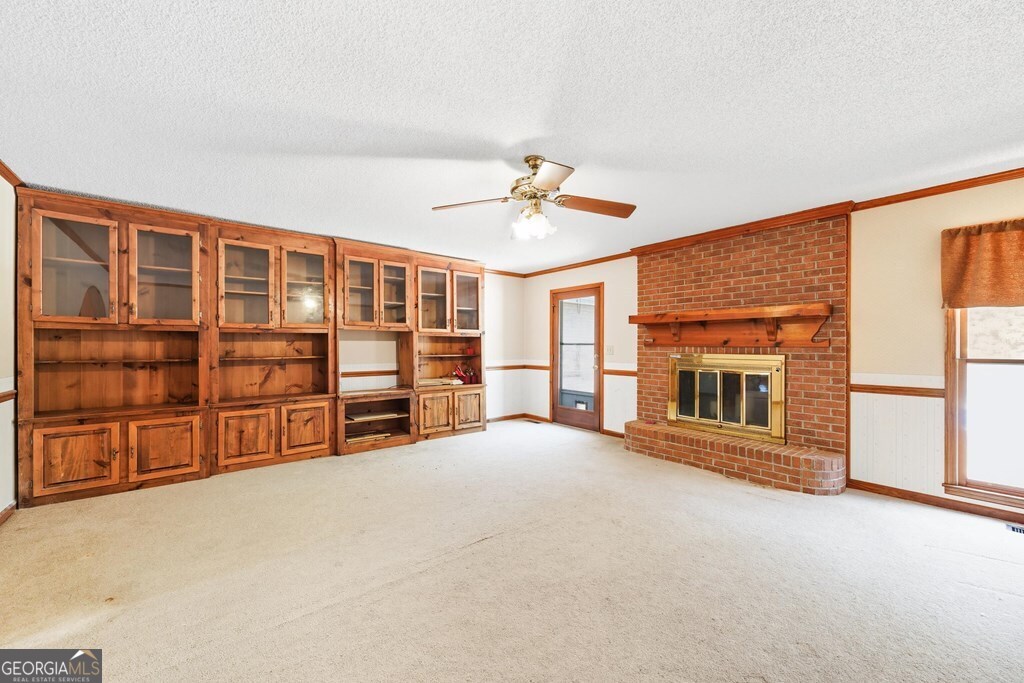 206 Ridge Circle Dublin, GA 31021 - Photo 5 of 23 a view of an empty room with a fireplace and cabinet