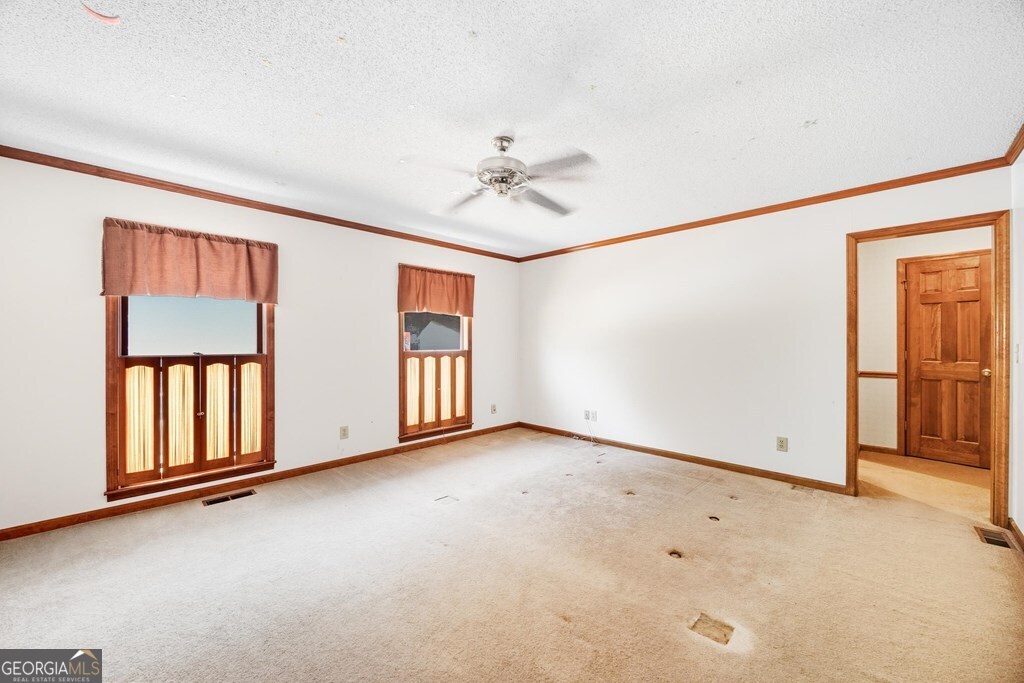 206 Ridge Circle Dublin, GA 31021 - Photo 9 of 23 an empty room with windows and ceiling fan view