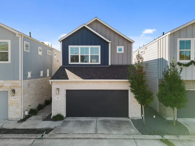 a front view of a house with garage