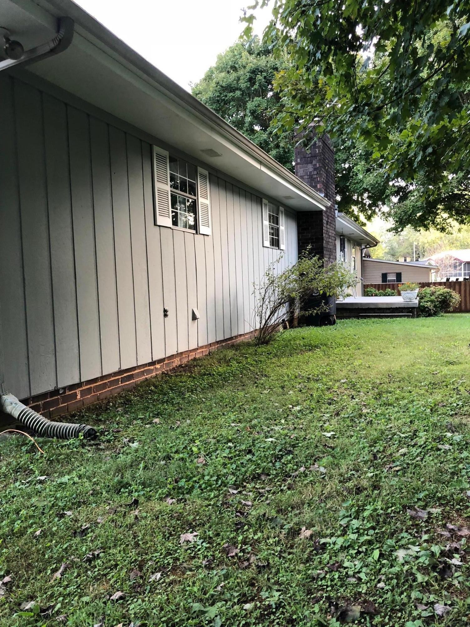 1215 Ridgeway Circle Athens, TN 37303 - Photo 2 of 7 a view of a backyard with potted plants and large tree