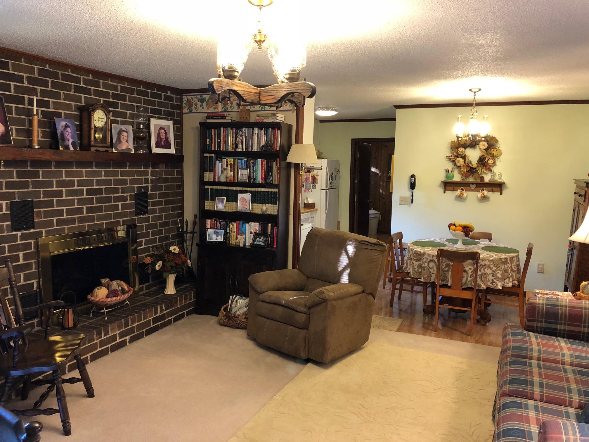 1215 Ridgeway Circle Athens, TN 37303 - Photo 5 of 7 a living room with furniture a rug and a fireplace