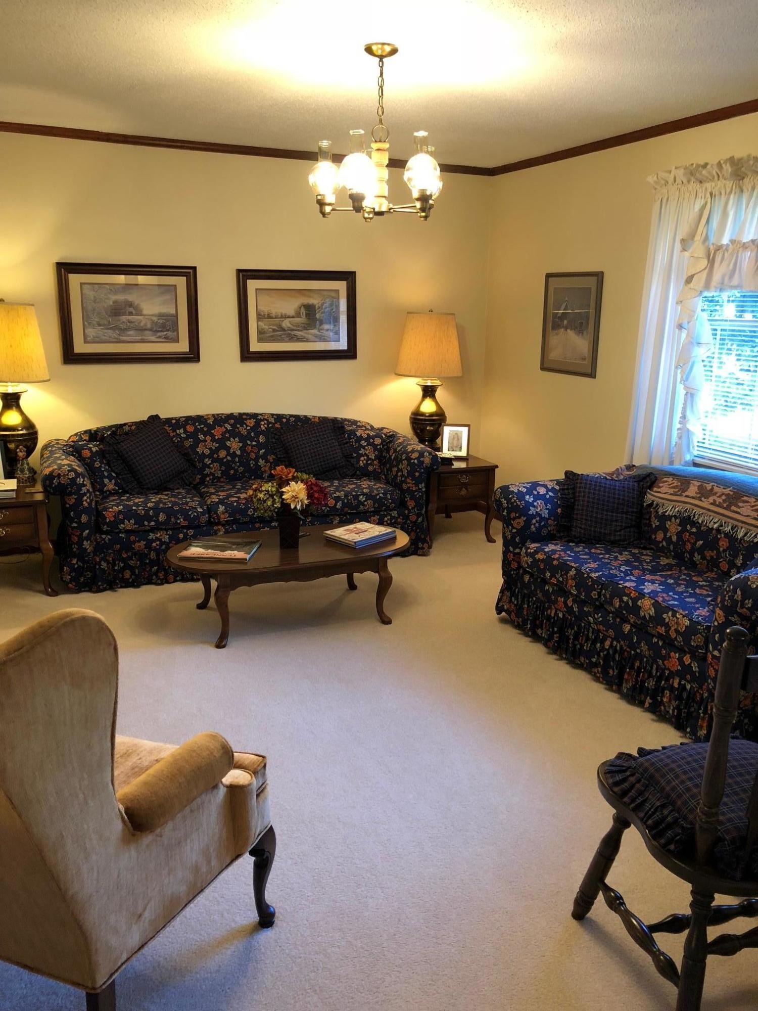 1215 Ridgeway Circle Athens, TN 37303 - Photo 6 of 7 a living room with furniture and a chandelier