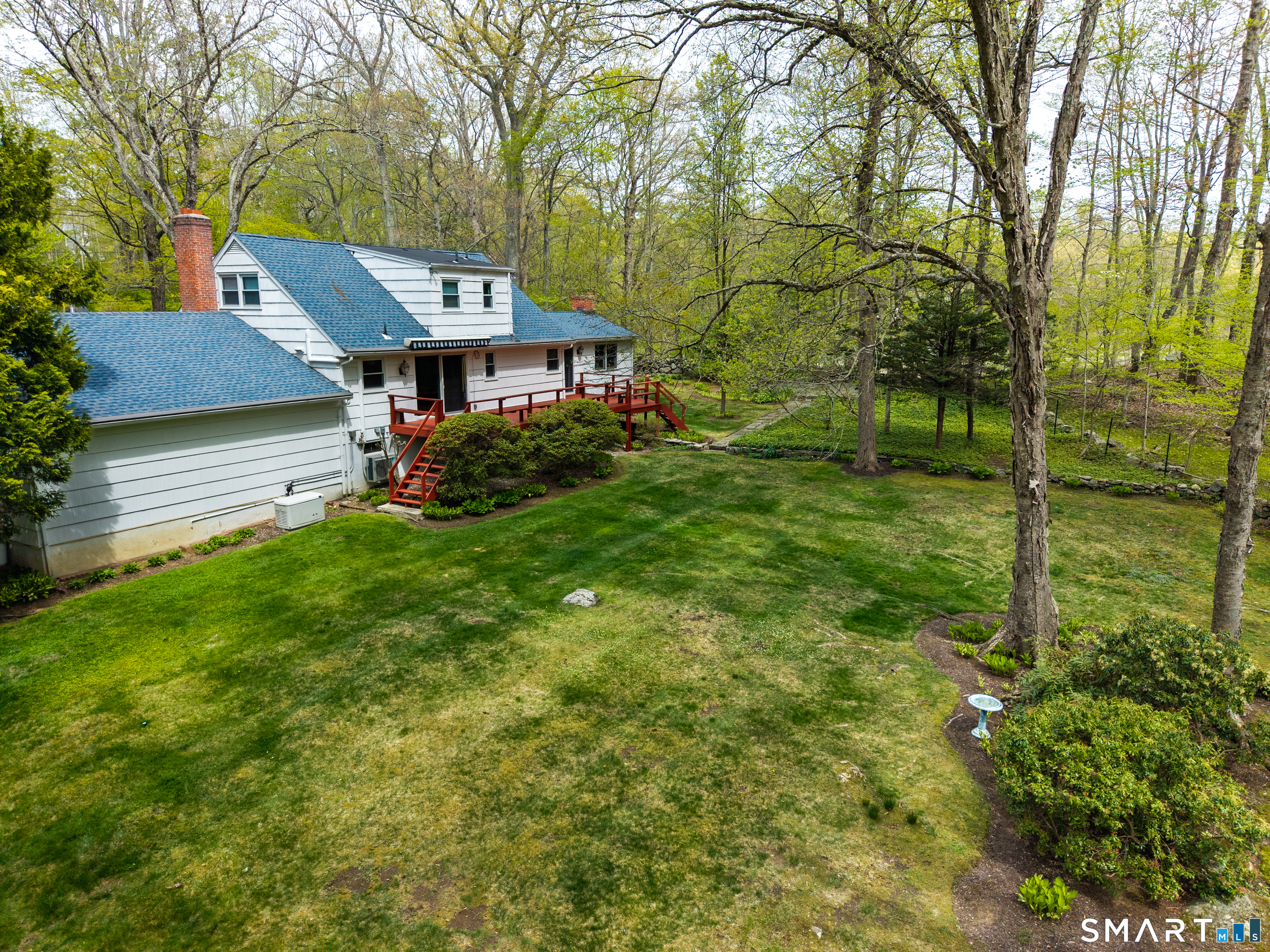 15 Limestone Terrace Ridgefield, CT 06877 - Photo 24 of 32 a backyard of a house with table and chairs