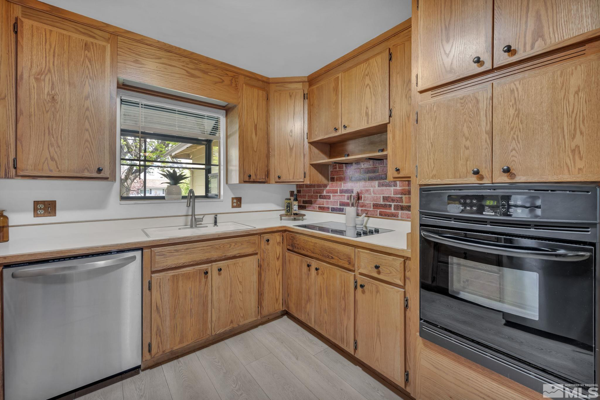 909 Norrie Drive Carson City, NV 89703 - Photo 12 of 39 a kitchen with stainless steel appliances granite countertop a stove a sink and a microwave