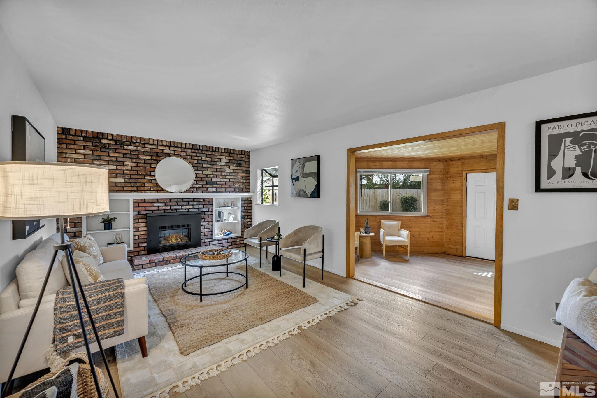 909 Norrie Drive Carson City, NV 89703 - Photo 13 of 39 a living room with furniture a fireplace and a table