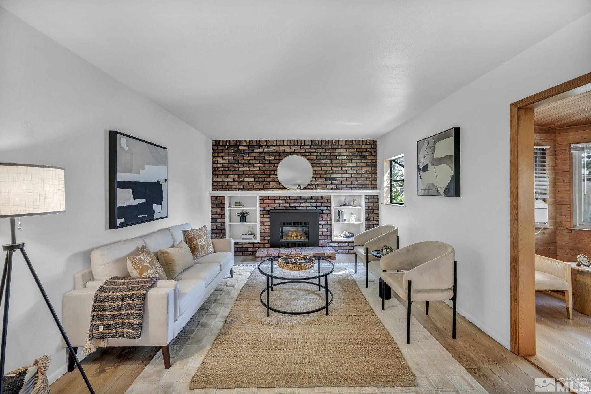 909 Norrie Drive Carson City, NV 89703 - Photo 14 of 39 a living room with furniture a rug and a fireplace