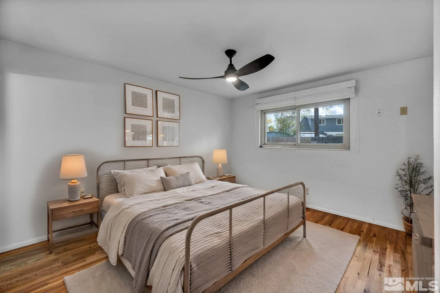 909 Norrie Drive Carson City, NV 89703 - Photo 18 of 39 a bedroom with a large bed and a chandelier