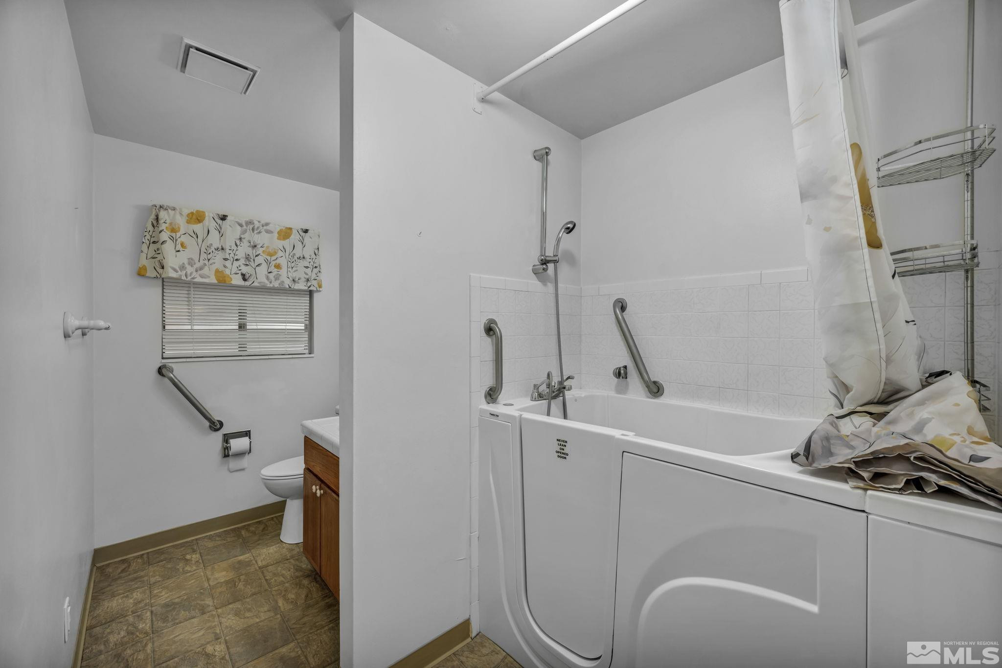 909 Norrie Drive Carson City, NV 89703 - Photo 26 of 39 a bathroom with a sink and mirror with toilet