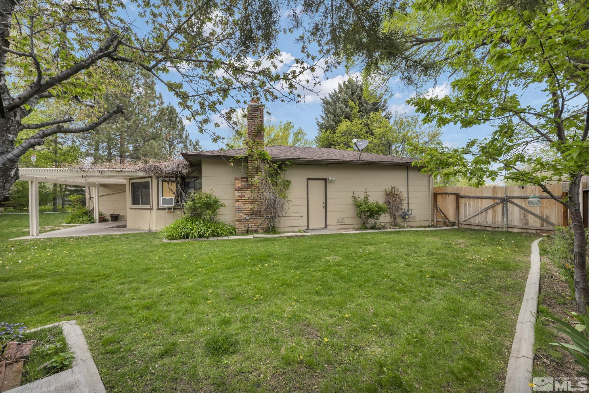 909 Norrie Drive Carson City, NV 89703 - Photo 28 of 39 a front view of a house with a garden