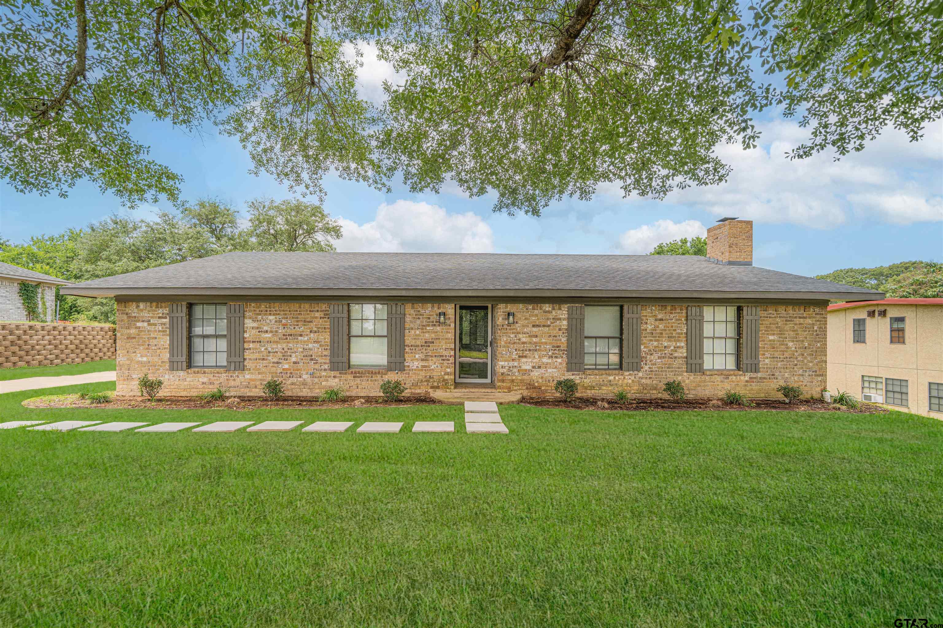 a front view of a house with a yard and porch