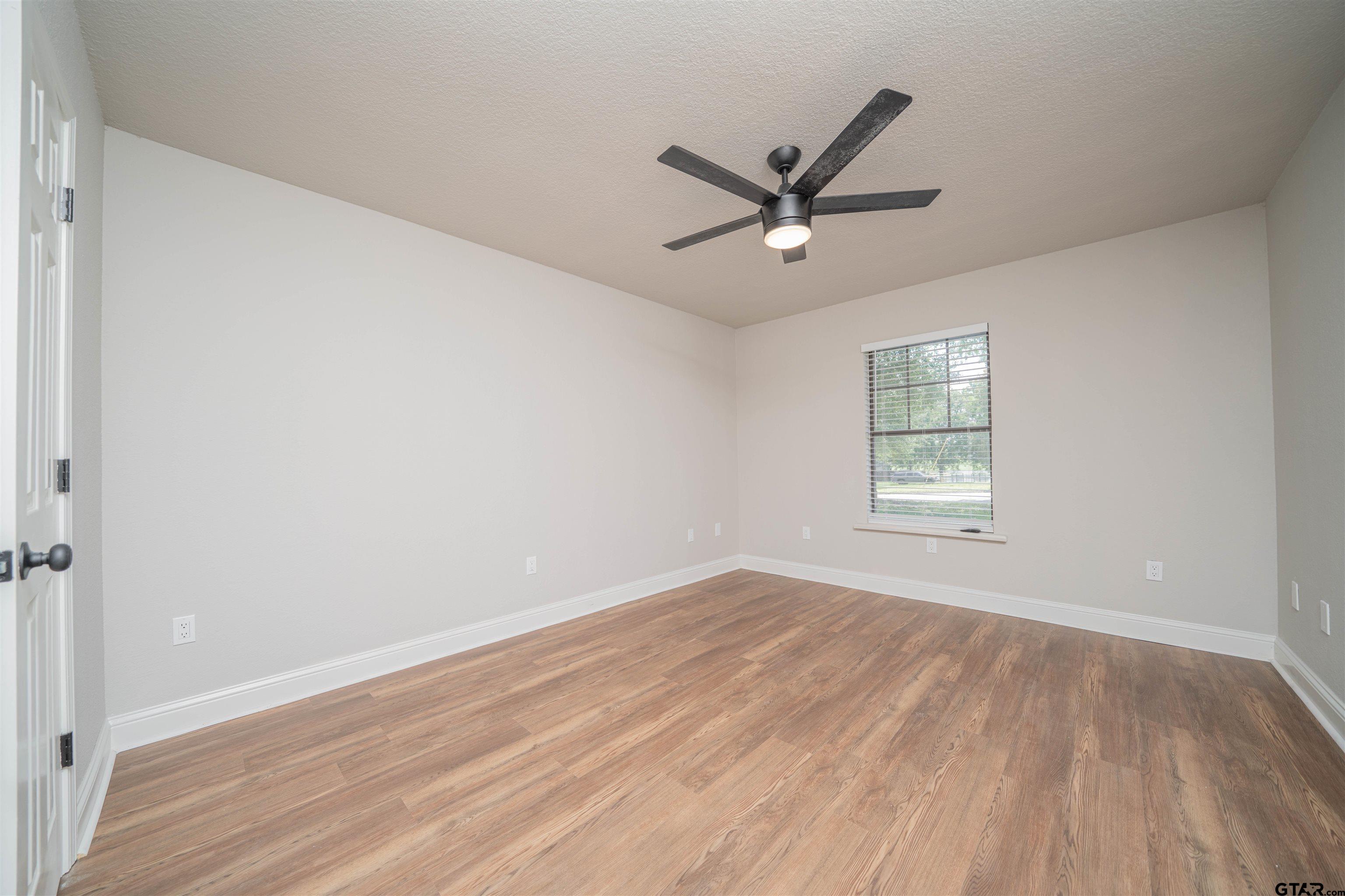 291 Taylor George Road Longview, TX 75605 - Photo 12 of 35 a view of a big room with wooden floor and windows