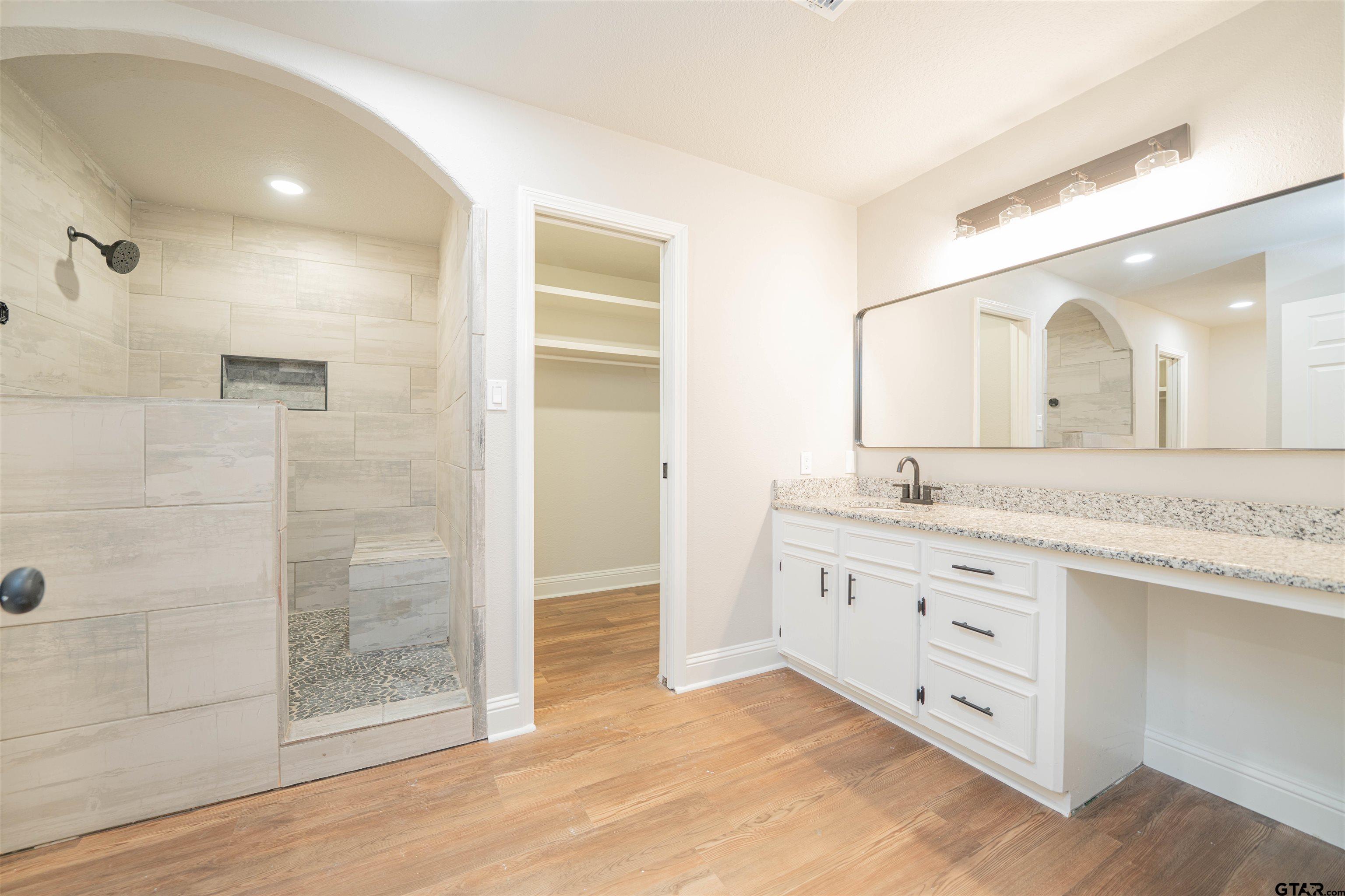 291 Taylor George Road Longview, TX 75605 - Photo 15 of 35 a bathroom with a granite countertop sink mirror and shower