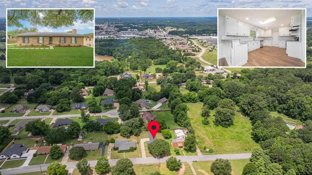 an aerial view of a residential houses with trees