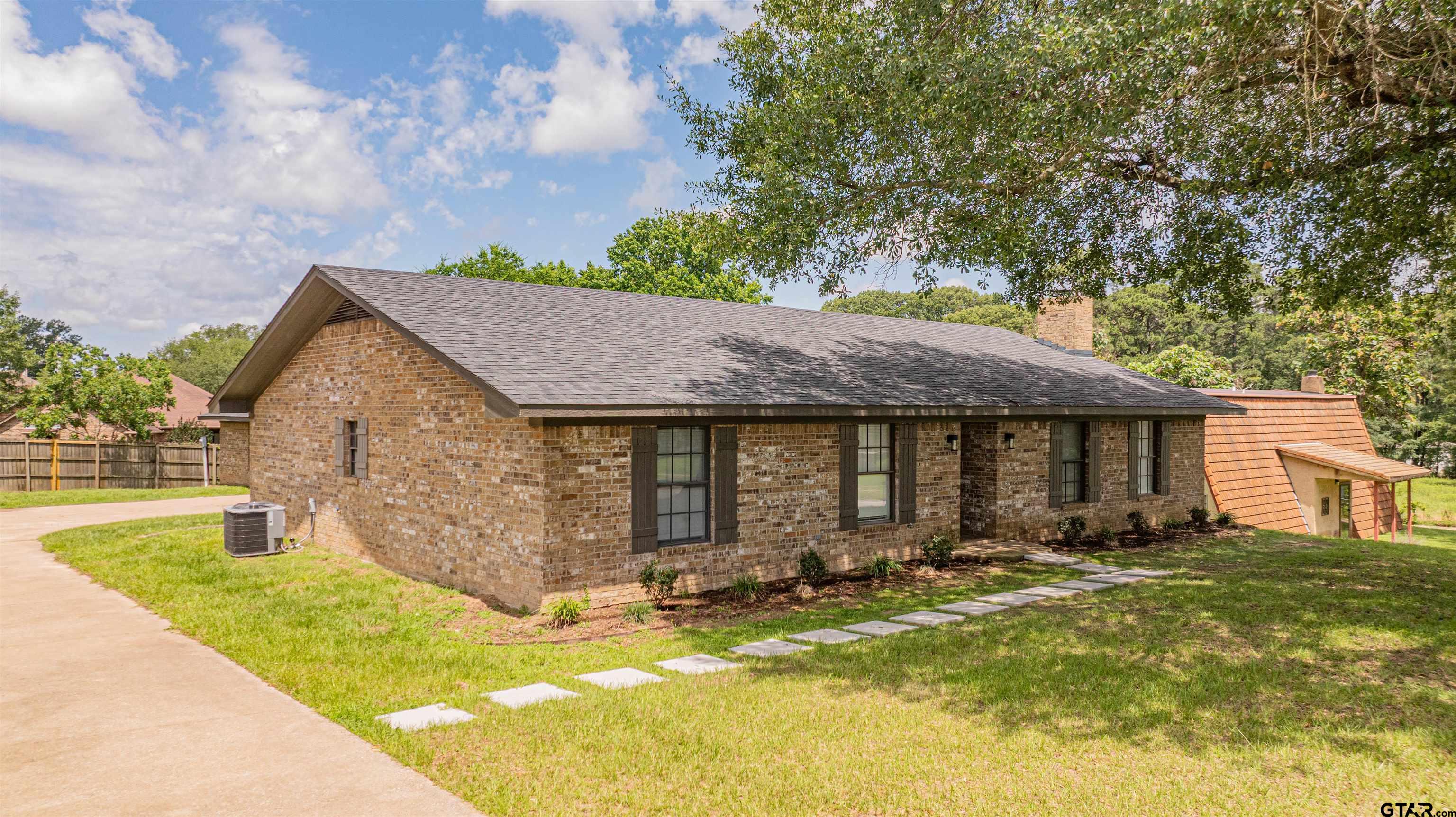 291 Taylor George Road Longview, TX 75605 - Photo 35 of 35 a front view of house with yard and trees in the background