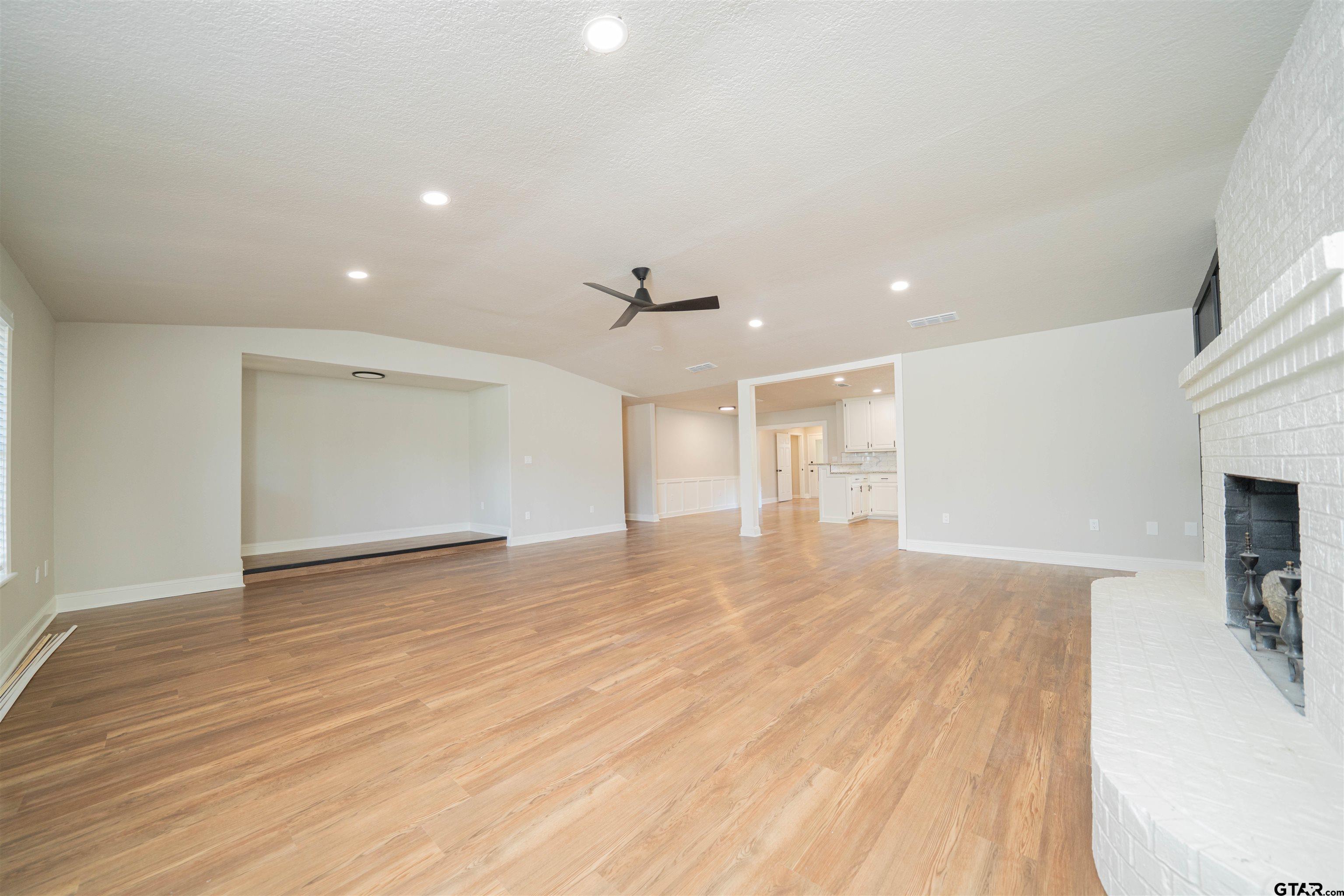 291 Taylor George Road Longview, TX 75605 - Photo 6 of 35 a view of empty room with wooden floor and fireplace