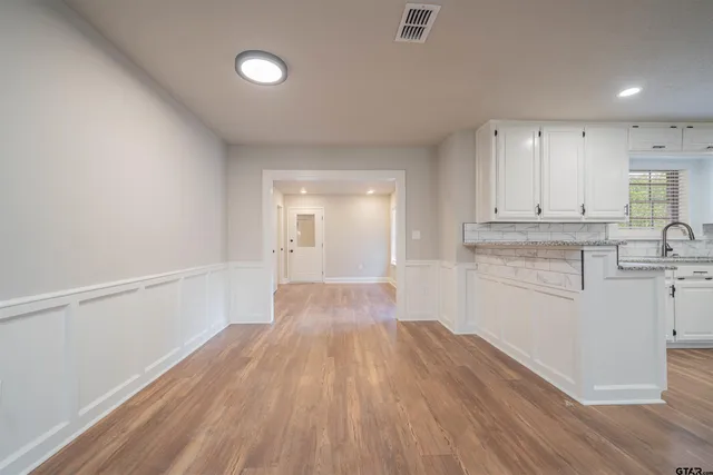 a view of a kitchen with wooden floor