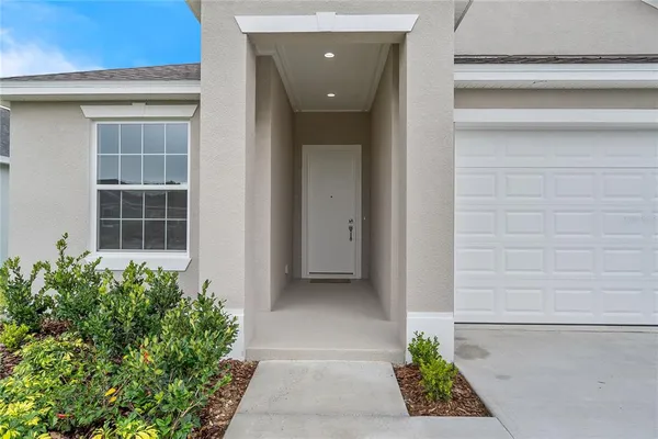 a view of empty room with wooden floor and windows