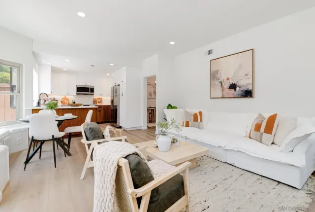 a living room with furniture and kitchen view