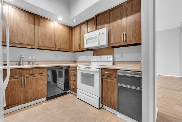 a kitchen with stainless steel appliances a refrigerator and a sink