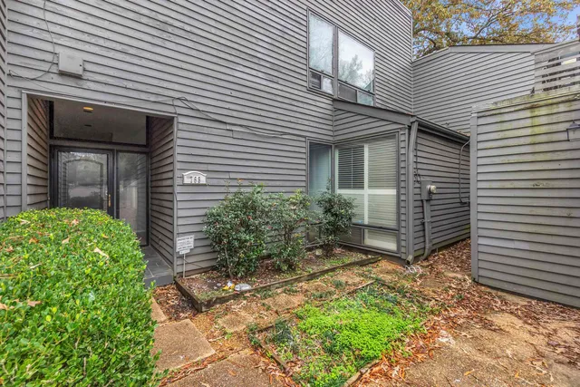 a view of a house with a yard and plants