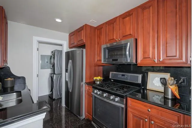 a kitchen with stainless steel appliances wooden cabinets and a stove top oven
