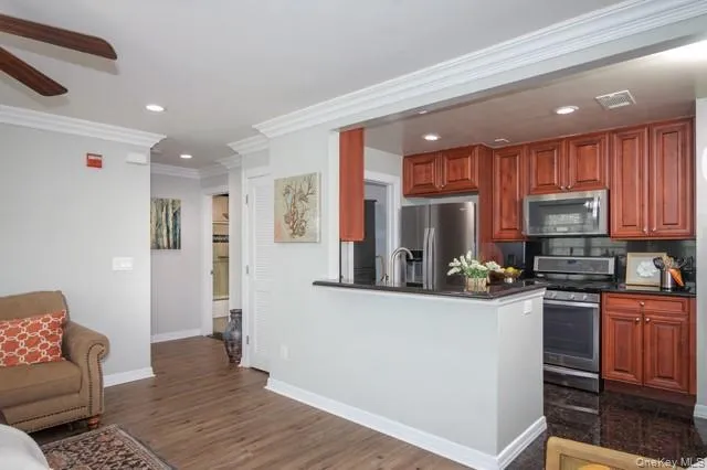 a kitchen with stainless steel appliances granite countertop a refrigerator a stove top oven a sink and dishwasher