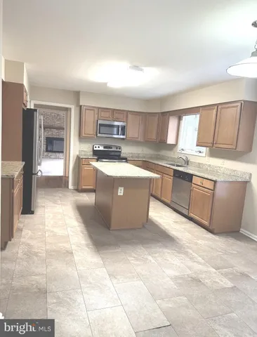 a kitchen with a sink a counter top space and appliances