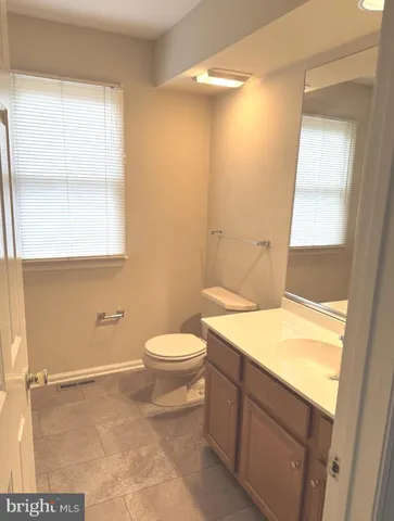 a bathroom with a sink a toilet and window